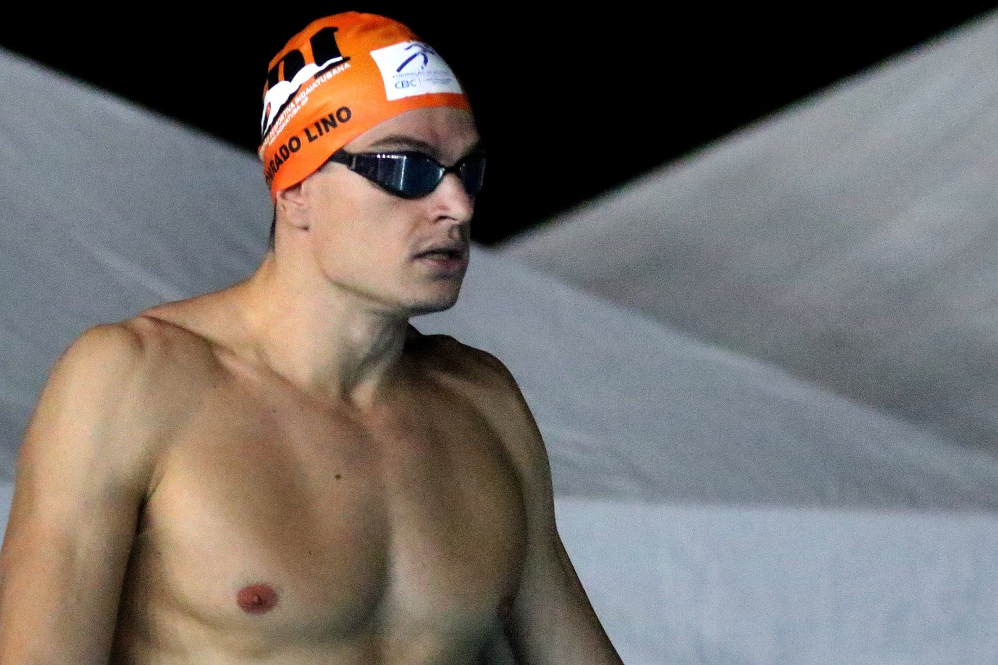 Conrado Lino parado na beira da piscina, antes da prova